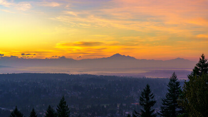 dawn breaking over mount baker as seen from a Burnaby Mountain residence