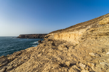 Beautiful white cliffs of limestone carved by wind and winter storms in Ajuy village on the Atlantic coast. Fuerteventura. Canary Islands. Spain.
