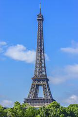 Fototapeta premium Tour Eiffel (Eiffel Tower) located on Champ de Mars, named after engineer Gustave Eiffel. Eiffel Tower is tallest structure in Paris and most visited monument in world. Paris, France.
