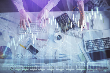 Double exposure of man and woman working together and financial chart hologram drawing. market analysis concept. Computer background. Top View.