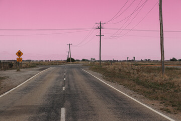 Fototapeta premium a deserted country road intersection at dawn