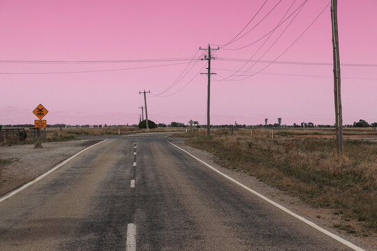 a deserted country road intersection at dawn