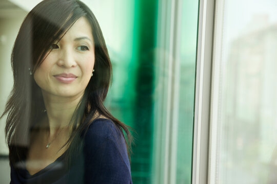 Chinese woman looking out window