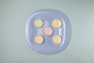 Five cakes on a blue plate. Pattern.