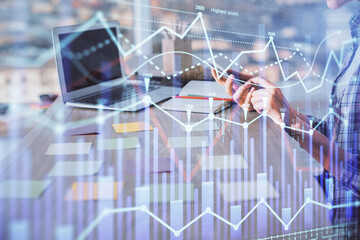 Double exposure of woman hands working on computer and forex graph hologram drawing. Financial analysis concept.