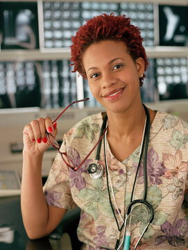 African female doctor in front of x-rays