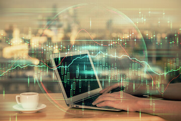 Double exposure of businesswoman hands typing on computer and forex chart hologram drawing. Financial analysis concept.