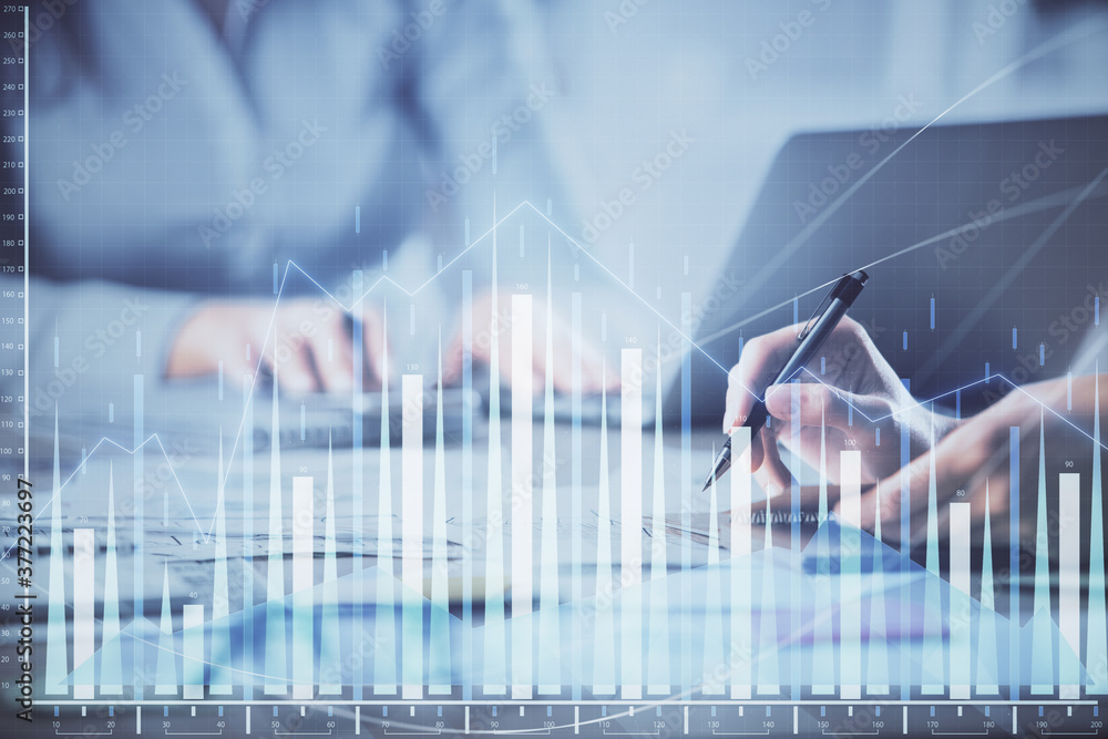 Wall mural multi exposure of woman hands typing on computer and financial chart hologram drawing. stock market 