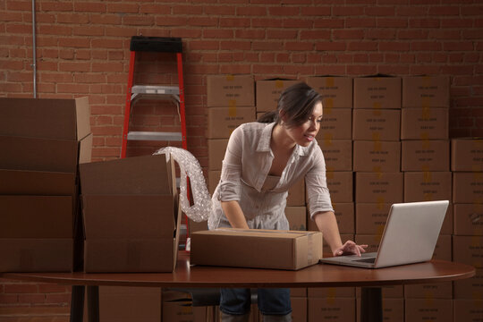 Hispanic woman typing on laptop