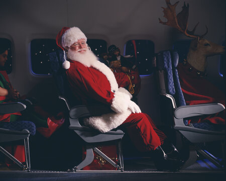 Santa Claus, elves, reindeer and presents on an airplane