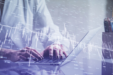 Double exposure of woman hands typing on computer and forex chart hologram drawing. Stock market invest concept.