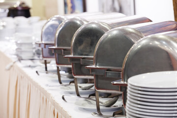 Metal food containers stand in a row