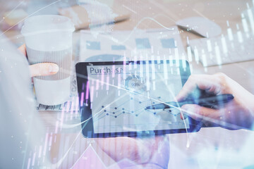 Double exposure of man's hands holding and using a phone and financial chart drawing. Market analysis concept.
