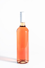 Rose wine bottle on the white table. Rosado, rosato or blush wine tasting in wineshop, bar concept. Copy Space