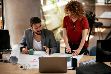 Businessman and businesswoman in office. Businesswoman and businessman working on the project..