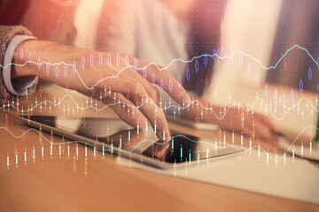 Double exposure of forex graph drawing and man and woman working together holding and using a mobile device. Trade concept.