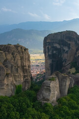 Vertical image of Gorgeous Meteora rocks with city and Valley behind 