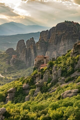 Fototapeta na wymiar Vertical image of Meteora rocks with Monastery in the morning mist
