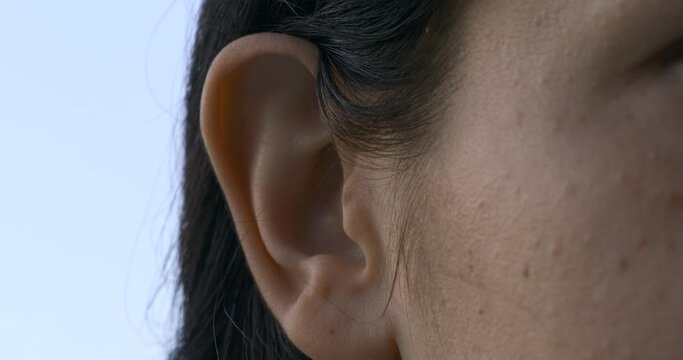 Close-up Female Ear. Outdoors Natural Lighting Morning Evening Time