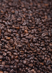Fresh raw organic coffee beans top view background.