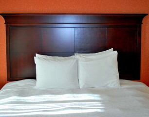 Bed with clean white sheets and pillow cases.