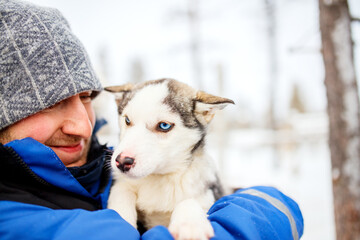 Man with husky puppy © TravelPhotoBloggers