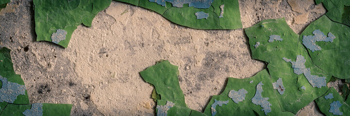 Peeling paint on the wall. Panorama of a concrete wall with old cracked flaking paint. Weathered rough painted surface with patterns of cracks and peeling. Wide panoramic texture for grunge background