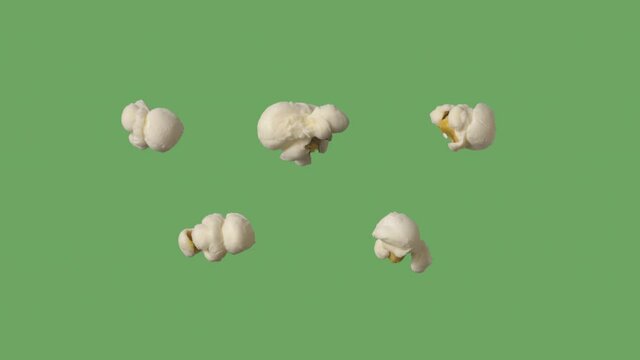Movie popcorn cooking and popping open on green screen or chroma key.