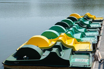 Colourful paddle boats on a beach