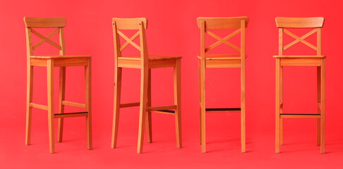 Set of wooden chairs on red background