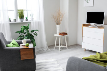 Armrest table on armchair in interior of room