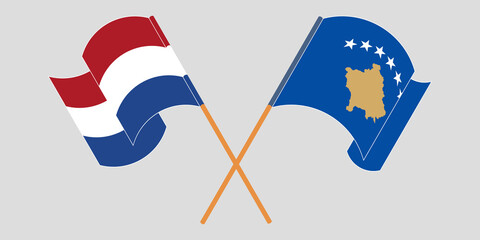 Crossed and waving flags of Kosovo and the Netherlands