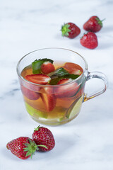 Tea with fresh strawberries, limes and mint