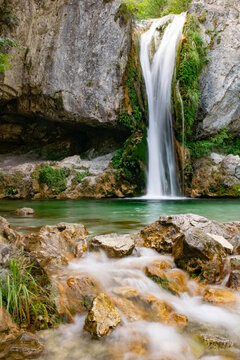 Long exposure image of waterfall and water flowing between rocks in the Mount Olympus, Greece
