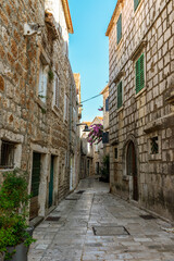Narrow street of Jelsa town, Hvar island, Croatia.