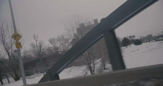 Montreal, Canada - November 15th 2017 : Driving on Mill Street during winter with snowy streets view, ADM flour mill building, factories near the port.