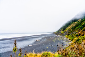 coastal beach in the fog, overcast, sand, ocean