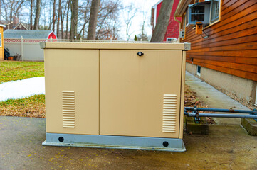 Residential standby generator at the house wall