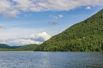 Paul Lake Summer time with green mountains and white clouds british columbia canada.
