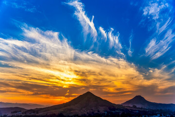 Colorful sunset, Clouds, over Silhouetted Mountains 