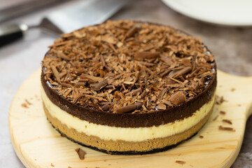 Homemade triple layers chocolate bake cheesecake in round shape