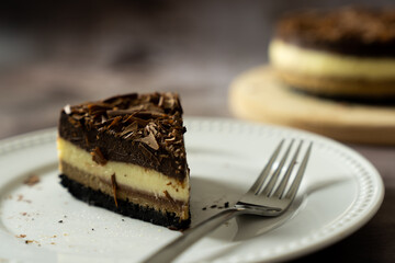 Piece of homemade triple layers chocolate bake cheesecake