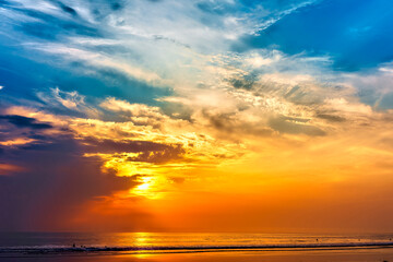 Naklejka na ściany i meble Sunset in the clouds at the beach, horizon