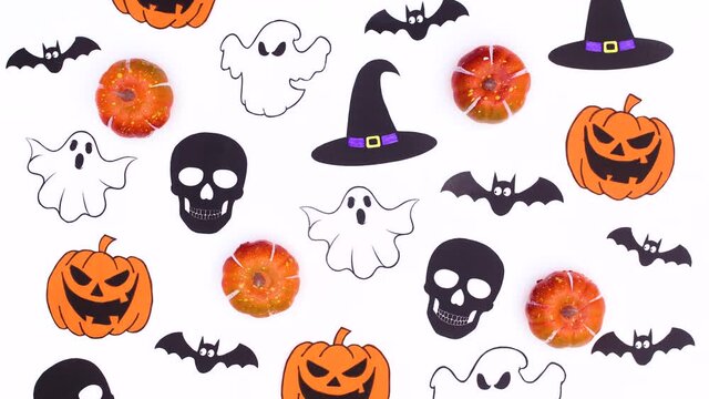 Halloween details, pumpkins, bats, skulls, ghosts appear on white theme. Stop motion 