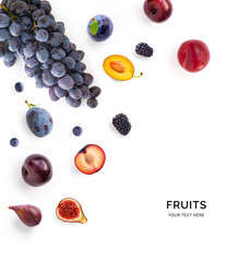 Creative layout made of fruits including: grapes, plums, figs, blueberries and blackberries on the white background.
