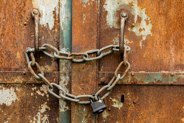 The chain used to lock rusty steel doors.