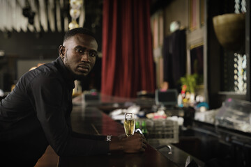 african american businessman relax and enjoy drink beer at counter bar