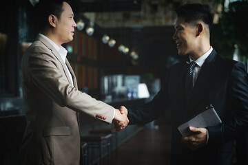asian businessman having handshake for business deal and agreement