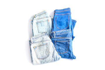 online shopping concept. set of jeans trousers of different colors on a white background. simple flat lay, top view