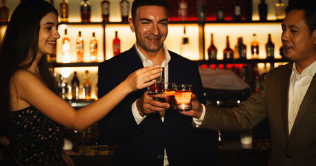 businesspeople toasting glasses of whiskey to celebrate friendship